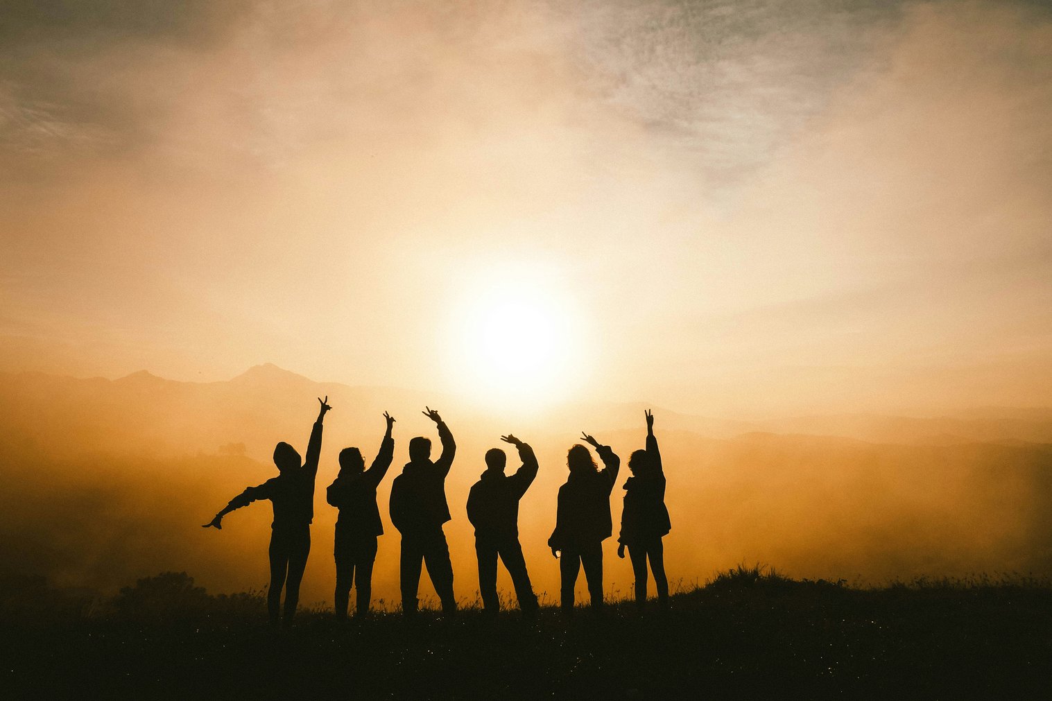 Silhouette photo of six persons on top of mountain