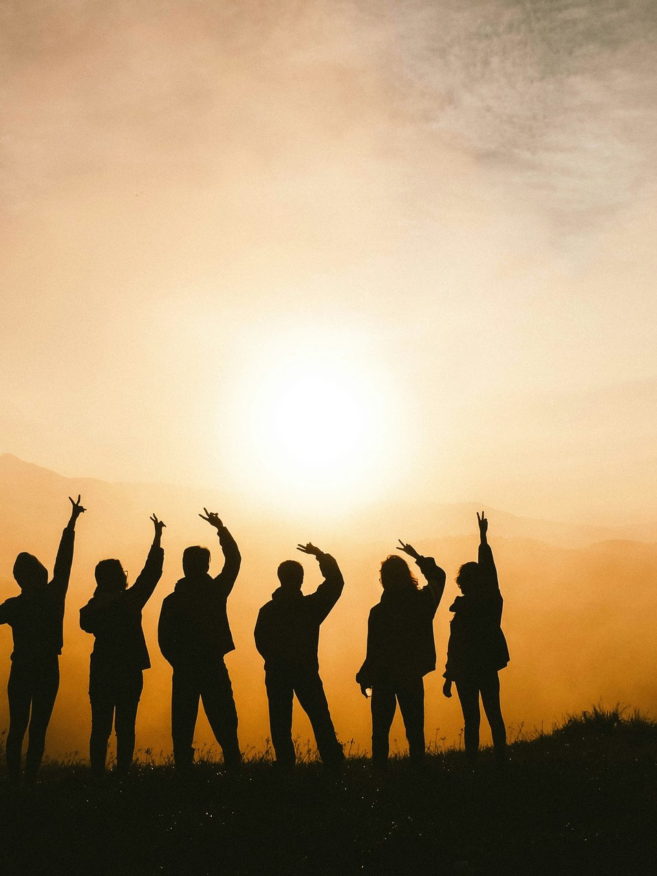 Silhouette photo of six persons on top of mountain